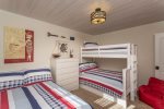 Enjoy this fun beach-themed bedroom equipped with two full size beds and 1 twin bed.